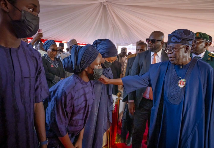 Public Reacts as President Tinubu Comforts Late COAS's Daughter at Burial